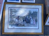Full view of framed artwork showing the scene with people on a path crossing a wooden plank bridge near creek.
