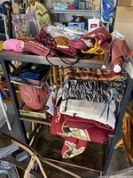Photo of shelves holding multiple Redskins memorabilia items including blankets, scarves, gloves, and football.