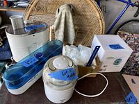 Overview of lot showing Krups juicer, yogurt maker with ceramic cups, ice cream maker, and accessory cups