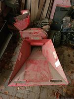 Front view of red Yardman SC 5 wood chipper with wide feed hopper and chute, showing dirt and leaves inside hopper area.