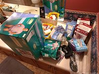 Photo showing multiple boxed items including Mens Depends adult diapers, medical supplies, and other personal care items on a bathroom counter.