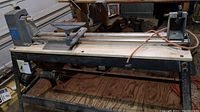 Full length view of the Rockwell Beaver 10-inch lathe showing metal bed, headstock, tool rests, and motor beneath.