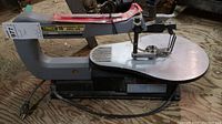 Side view of the TradeMaster 16" variable speed scroll saw showing the work table and blade holder.