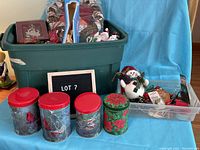 Full view of bin with red and green decorative canisters in front, a snowman figurine, and assorted holiday items visible inside larger bin