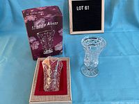 Two crystal vases shown together; one boxed Cristal d'Arques vase in original packaging and one unboxed cut crystal vase.
