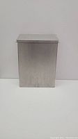 Front and side view of stainless steel rectangular hygiene trash bin against a white background.