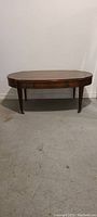 Front view of the antique mahogany coffee table with straight legs and drawer visible