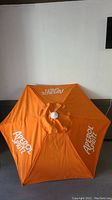 Orange Aperol Spritz patio umbrella showing full top view with branding
