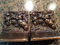 Front view of both bookends showing three foxes in detailed relief.