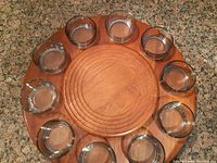 Top view of the full Lazy Susan set showing wooden base and 10 glass bowls arranged around it.