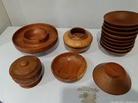 Full lot, includes stack of small bowls, large segmented container, pedestal bowl, round bowl, and lidded container