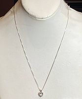 Full view of 14K white gold box chain necklace with heart-shaped diamond pendant on white display bust