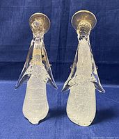 Front view of two Murano glass angel figurines showing clear glass with gold fleck infusion, elongated flowing body, and round halos.