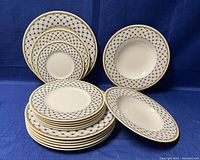 Porcelain plates and bowls arranged on blue background showing size variation and pattern.