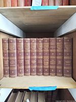 Photo of one shelf with eleven Harvard Classics volumes, brown leather bound with gold embossed text, volume numbers 1 to 10 and 22.