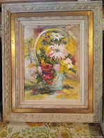 Frontal image of framed oil painting showing colorful flowers in a vase with a gold and neutral toned carved wooden frame.