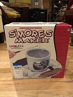 Front of the boxed Casamoda indoor/outdoor s'mores maker showing product image and brand name.