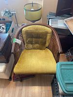 Full view of the chair showing the yellow velour cushions, wooden barrel back frame and cane sides.