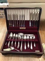 Opened case showing full set of knives in top slot and assorted pieces below