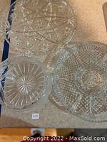 Top-down view of all three cut crystal pieces arranged on a surface showing varying sizes and patterns