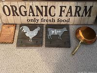 Full view of all farmhouse decor items: large wooden Organic Farm sign, two wood and galvanized steel animal frames, vintage copper art piece, and copper fry pan.