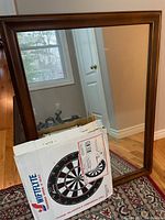 Large solid wood frame mirror approximately 30 x 39 inches, standing on a decorative rug.