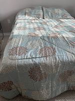 Top view of the bed featuring comforter and two pillow shams with floral pattern