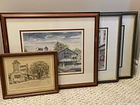 Four framed Unionville artworks displayed together, showing original drawing and three prints
