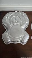 Aluminum cake pan shaped like a Cabbage Patch doll with detailed facial and hair features.