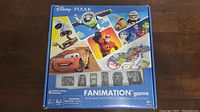 Box cover of Disney Pixar Fanamation game showing characters from Pixar movies and the game board image