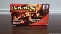 Front view of a red box labeled StarterLogg with flames graphic and branding details