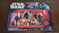 Front of the box showing Star Wars branding and 8 puzzle images previewed, each containing 1000 pieces.