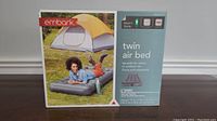 Photo of the Embark Twin Air Bed in its original packaging depicting a person lying on the air bed outdoors by a tent, box includes product features and specifications.