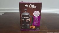 Front view of the boxed Mr. Coffee Coffee Press showing brand, product type, and features.