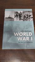 Front cover of the book showing the title 'World War 1 In Photographs' by J.H.J. Andriessen and historical black-and-white images including a naval ship, soldiers on horseback, and soldiers in trenches.