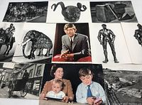 Top view showing various black and white postcards with images of armor sculptures, artifact replicas, and a color portrait of a teenage Prince Charles in a suit.