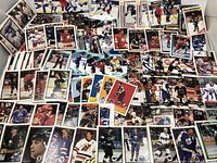 Spread of assorted NHL hockey cards laid out to show various player images and teams.