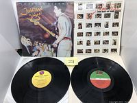 Two vinyl LP albums displayed with their covers and records visible: 'Jonathan Sings!' by Jonathan Richman and 'Prime Prine - The Best Of John Prine'.