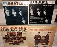 Four Beatles vinyl LP albums covers visible: Meet The Beatles, Beatlemania, Long Tall Sally, Introducing The Beatles.