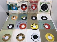 Front view of first set of 45 rpm singles in paper sleeves from labels Atlantic, RCA Victor, London, MGM, Capitol, and others.