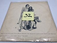 Front side of album cover featuring nude figures of John Lennon and Yoko Ono, worn with creases and discoloration.