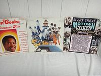 Front view of three vinyl records: Sam Cooke's Greatest Hits, My & H Plains Society Orchestra album, and Every Great Motown Song compilation.