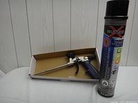 Black and gray aerosol can of Givenco Gun Foam Mousse Pistolet and applicating gun tool in a cardboard box.