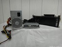 Photo of the lot showing Nvidia GTX 1060 graphics card, power supply unit, and two hard drives