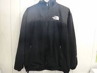 Front view of the black fleece jacket by The North Face, size small with Gore-Tex and full front zipper.