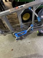 Blue Razor mini scooter with three wheels on concrete floor