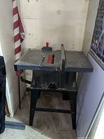 Photo of a large used stationary table saw with metal table surface and integrated fence.