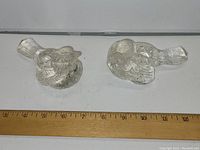 Front view of two glass bird candle holders side by side with a ruler showing size about 4 inches.