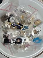 Overview photo of various vintage costume jewelry items in multiple ziplock bags showing necklaces, bracelets, earrings and brooches.
