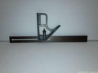 Side profile of the Stanley carpenter's square showing the metal ruler and cast metal handle with a marking pin.